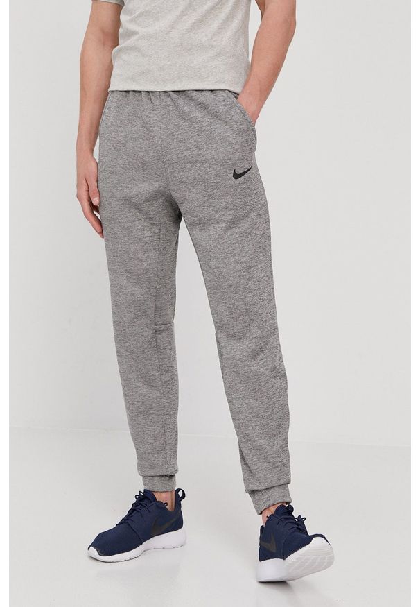 Nike - Spodnie. Kolor: szary