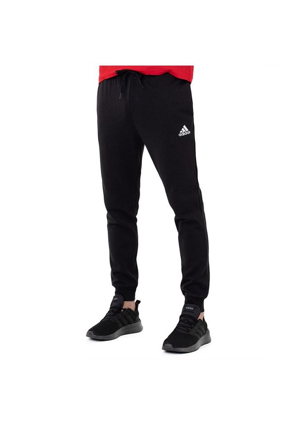 Adidas - Spodnie adidas Essentials Fleece Regular Tapered HL2236 - czarne. Kolor: czarny. Materiał: dresówka, tkanina, poliester, bawełna