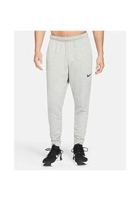 Spodnie sportowe męskie Nike Drifit Trapered. Kolor: szary. Materiał: dresówka. Długość: długie