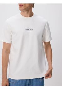 Reserved - T-shirt comfort z nadrukiem - złamana biel. Materiał: dzianina, bawełna. Wzór: nadruk