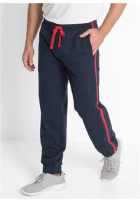 bonprix - Spodnie sportowe z kontrastowymi elementami. Kolor: niebieski. Materiał: dresówka. Styl: sportowy #1
