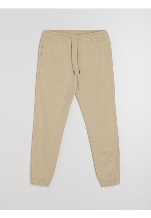 Sinsay - Bawełniane spodnie jogger - beżowy. Kolor: beżowy. Materiał: bawełna