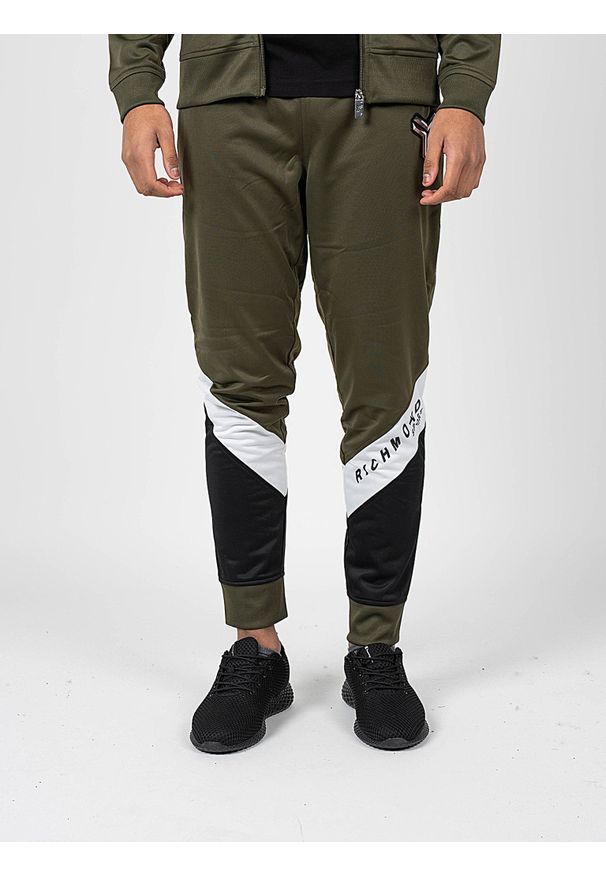 John Richmond - Richmond Sport Spodnie | UMA22075PA | Mężczyzna | Khaki. Okazja: na co dzień. Kolor: brązowy. Materiał: poliester. Wzór: aplikacja, nadruk. Styl: sportowy