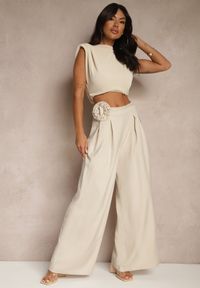 Renee - Beżowe Spodnie o Szerokim Kroju High Waist z Kwiatem 3D Firalisse. Okazja: na co dzień. Stan: podwyższony. Kolor: beżowy. Wzór: kwiaty. Styl: klasyczny, elegancki, casual