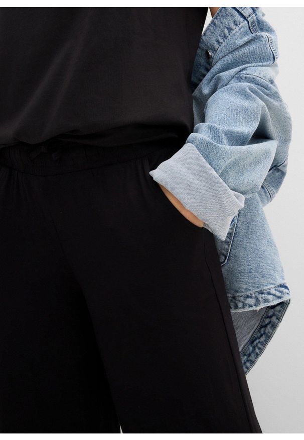 bonprix - Spodnie z dżerseju z lejącej mieszanki wiskozy. Kolor: czarny. Materiał: wiskoza, jersey