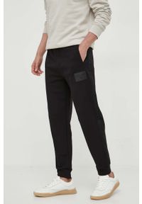 Armani Exchange spodnie dresowe bawełniane kolor czarny gładkie. Kolor: czarny. Materiał: bawełna, dresówka. Wzór: gładki #1
