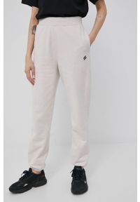 Superdry spodnie damskie kolor beżowy gładkie. Stan: podwyższony. Kolor: beżowy. Materiał: dzianina. Wzór: gładki
