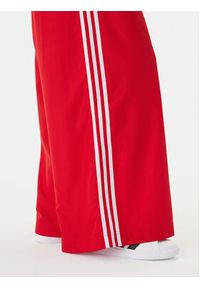Adidas - adidas Spodnie dresowe Firebird Adilenium KD6299 Czerwony Regular Fit. Kolor: czerwony. Materiał: syntetyk #3