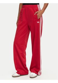 Adidas - adidas Spodnie dresowe Firebird Loose Tracksuit KS4670 Czerwony Loose Fit. Kolor: czerwony. Materiał: syntetyk #1