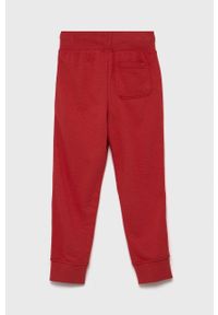 GAP Spodnie dziecięce kolor czerwony gładkie. Kolor: czerwony. Materiał: dzianina. Wzór: gładki