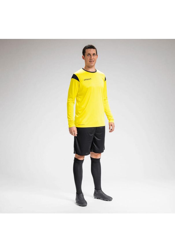 UHLSPORT - Dziecięcy dżersej z długim rękawem Uhlsport Squad 27. Kolor: wielokolorowy, żółty, czarny. Materiał: jersey. Długość rękawa: długi rękaw. Długość: długie. Wzór: kolorowy