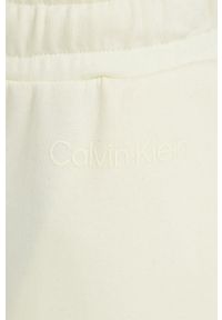 Calvin Klein spodnie dresowe damskie kolor żółty gładkie. Kolor: żółty. Materiał: dresówka. Wzór: gładki #3