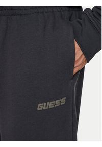 Guess Spodnie dresowe Emis Z4YB00 KAIJ1 Czarny Relaxed Fit. Kolor: czarny. Materiał: bawełna