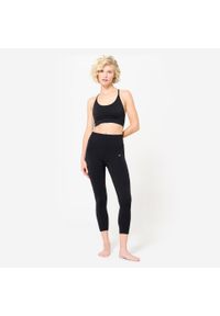 Decathlon - Stanik sportowy Kimjaly. Kolor: czarny. Materiał: materiał, poliamid, elastan. Rodzaj stanika: wyciągane miseczki. Sport: joga i pilates