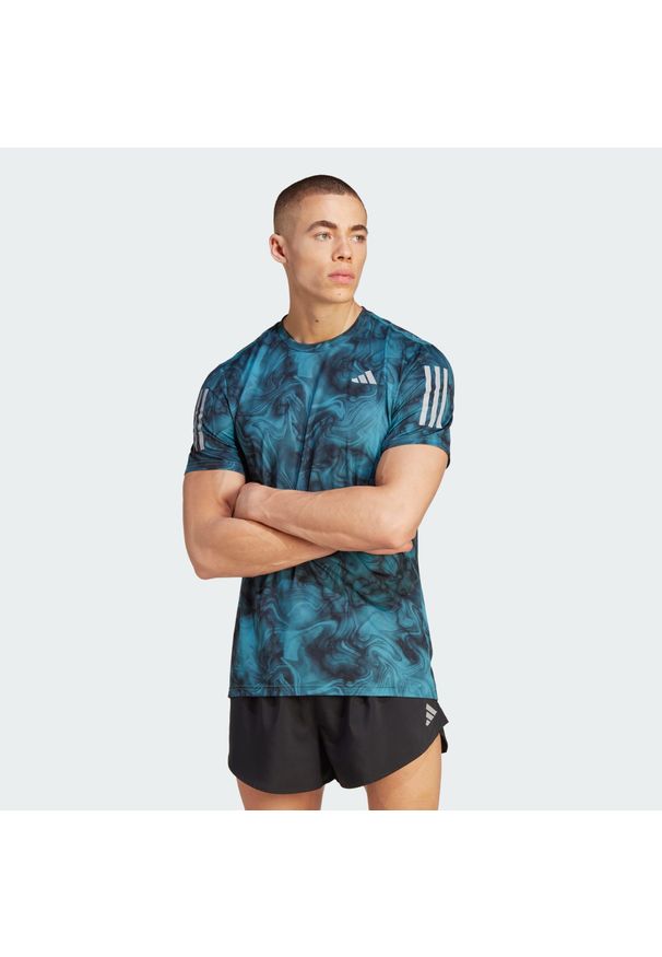 Adidas - Koszulka Own the Run Allover Print. Kolor: niebieski, wielokolorowy, czarny. Materiał: materiał. Wzór: nadruk. Sport: bieganie