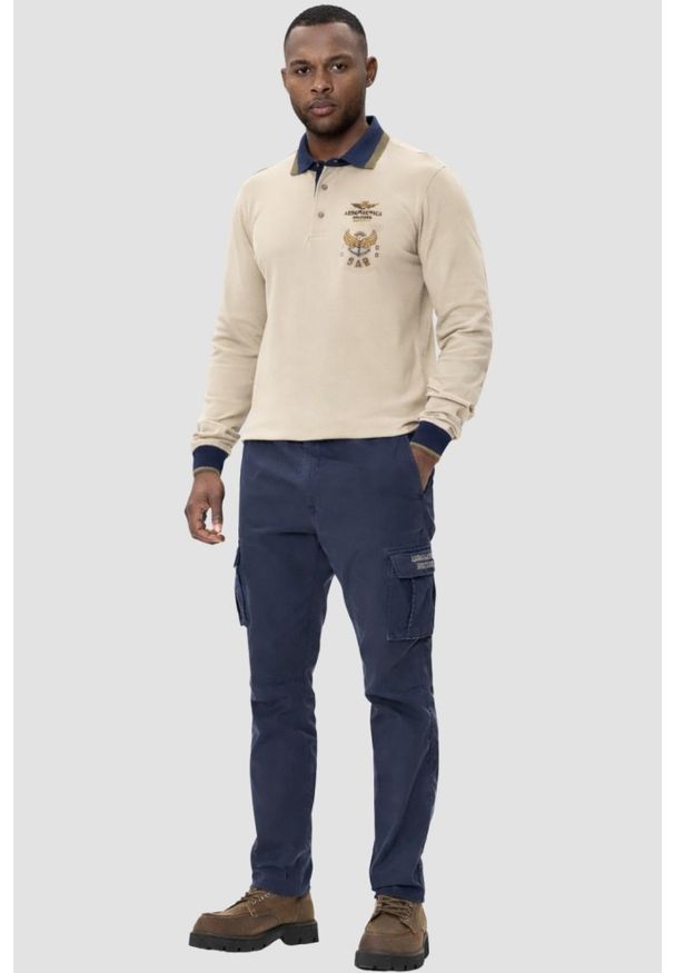 Aeronautica Militare - AERONAUTICA MILITARE Beżowy bawełniany męski longsleeve polo, Rozmiar 3XL. Okazja: na co dzień. Typ kołnierza: polo. Kolor: beżowy. Materiał: bawełna. Długość rękawa: długi rękaw. Wzór: aplikacja. Styl: casual, sportowy