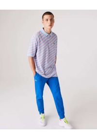 Lacoste - LACOSTE - Niebieskie spodnie dresowe Sport Tennis. Kolor: niebieski. Materiał: dresówka. Wzór: haft. Sport: kolarstwo, fitness #4