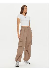 New Balance Spodnie dresowe WP43534 Beżowy Relaxed Fit. Kolor: beżowy. Materiał: syntetyk #4