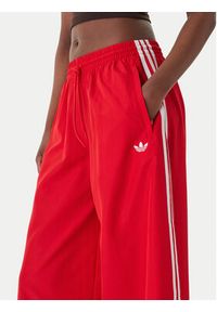 Adidas - adidas Spodnie dresowe Firebird Adilenium KD6299 Czerwony Regular Fit. Kolor: czerwony. Materiał: syntetyk #4