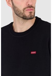 Guess - GUESS Czarna bluza regular fit. Kolor: czarny. Wzór: aplikacja