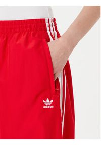 Adidas - adidas Spodnie dresowe adicolor Firebird JD3388 Czerwony Loose Fit. Kolor: czerwony. Materiał: syntetyk #5