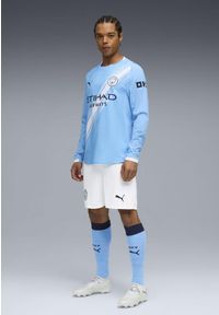 Puma - Męska autentyczna koszulka domowa z długim rękawem Manchester City 25/26 PUMA. Kolor: biały, niebieski, wielokolorowy. Długość rękawa: długi rękaw. Długość: długie. Wzór: aplikacja, paski