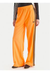 Adidas - adidas Spodnie dresowe adicolor Classic Firebird JY2694 Żółty Loose Fit. Kolor: żółty. Materiał: syntetyk #1