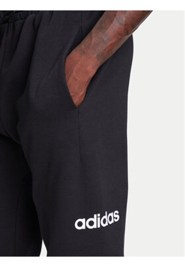 Adidas - adidas Spodnie dresowe Essentials Linear Fleece JN1786 Czarny Regular Fit. Kolor: czarny. Materiał: syntetyk, bawełna