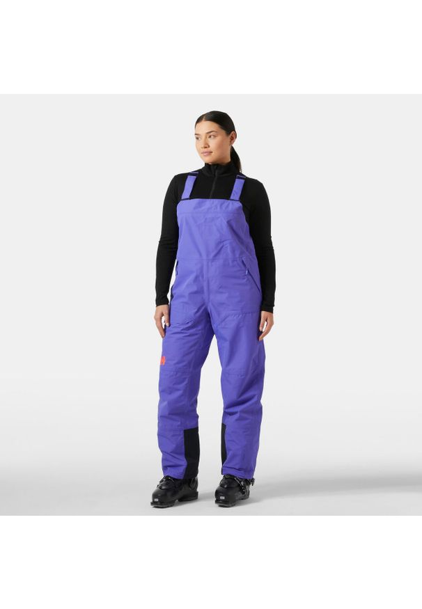 Damski kombinezon narciarski Helly Hansen Emiko Shell Bib. Kolor: fioletowy. Sezon: zima. Sport: narciarstwo