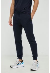 Guess spodnie dresowe kolor granatowy melanżowe. Kolor: niebieski. Materiał: dresówka. Wzór: melanż