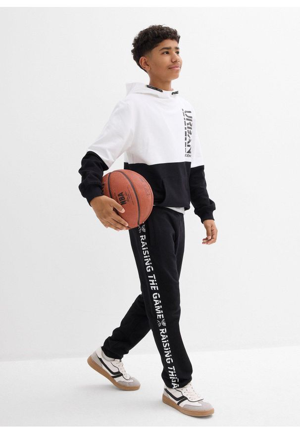 bonprix - Spodnie dresowe z czystej bawełny organicznej. Kolor: czarny. Materiał: bawełna, dresówka. Wzór: napisy