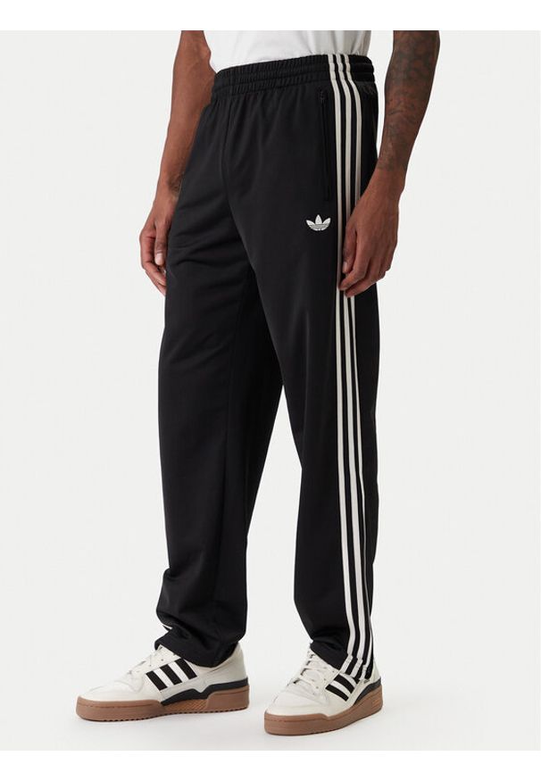 Adidas - adidas Spodnie dresowe Firebird KD8315 Czarny Loose Fit. Kolor: czarny. Materiał: syntetyk