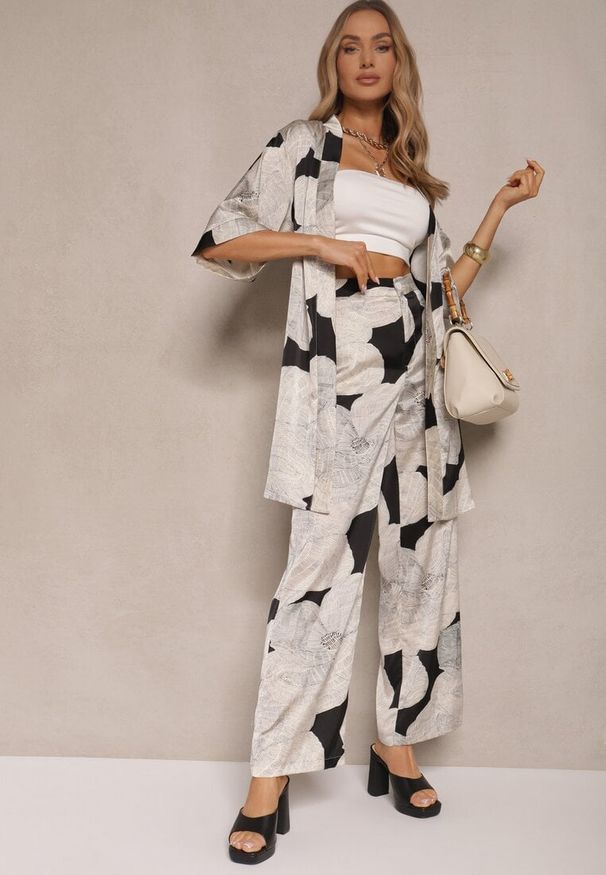 Renee - Beżowa Marynarka Satynowa Narzutka z Wiskozą w Kwiaty Ozdobiona Wiązaniem Halannia. Okazja: na co dzień, na spotkanie biznesowe. Kolor: beżowy. Materiał: wiskoza, satyna. Wzór: aplikacja, kwiaty. Styl: biznesowy, casual, klasyczny