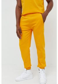 ARKK Copenhagen - Arkk Copenhagen spodnie dresowe bawełniane kolor żółty gładkie. Kolor: żółty. Materiał: bawełna, dresówka. Wzór: gładki #7