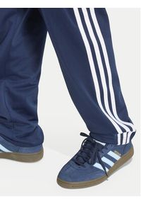 Adidas - adidas Spodnie dresowe Firebird HZ6650 Granatowy Regular Fit. Kolor: niebieski. Materiał: syntetyk #3