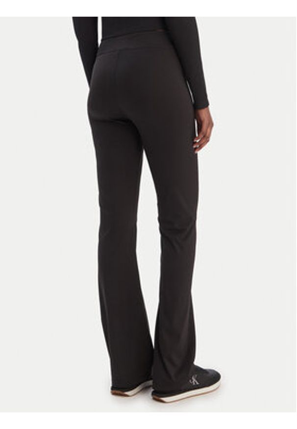 Tommy Jeans Legginsy Kick DW0DW22110 Czarny Flare Fit. Kolor: czarny. Materiał: syntetyk