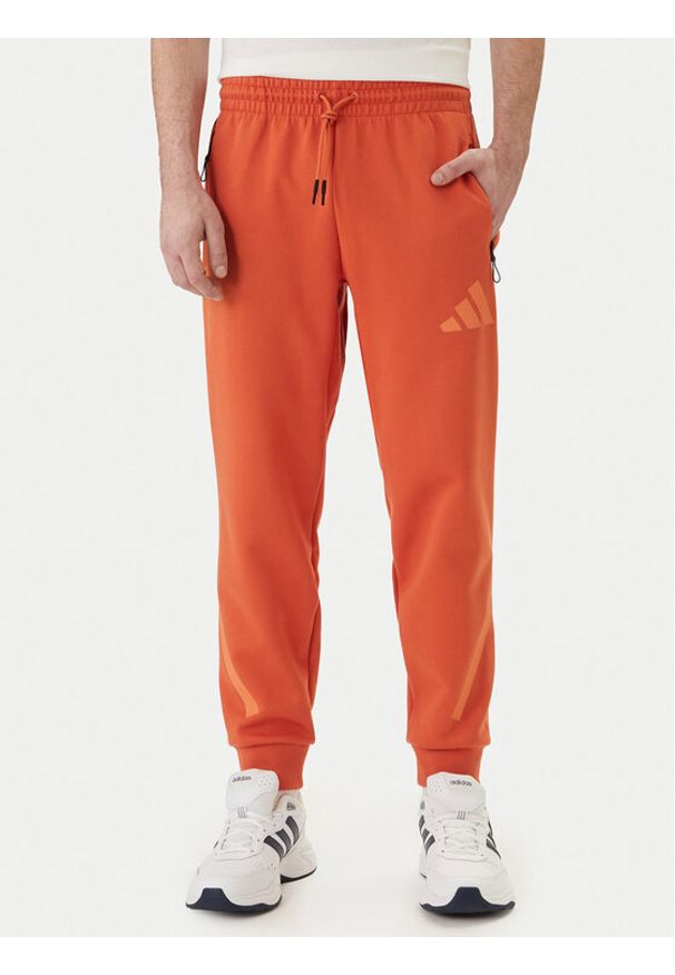 Adidas - adidas Spodnie dresowe Z.N.E. KE4686 Pomarańczowy Regular Fit. Kolor: pomarańczowy. Materiał: bawełna