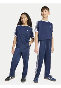 Adidas - adidas Spodnie dresowe Firebird HZ6650 Granatowy Regular Fit. Kolor: niebieski. Materiał: syntetyk #1