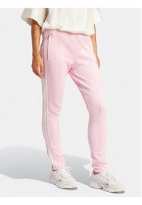 Adidas - adidas Spodnie dresowe adicolor SST IR8076 Różowy Slim Fit. Kolor: różowy. Materiał: bawełna #6