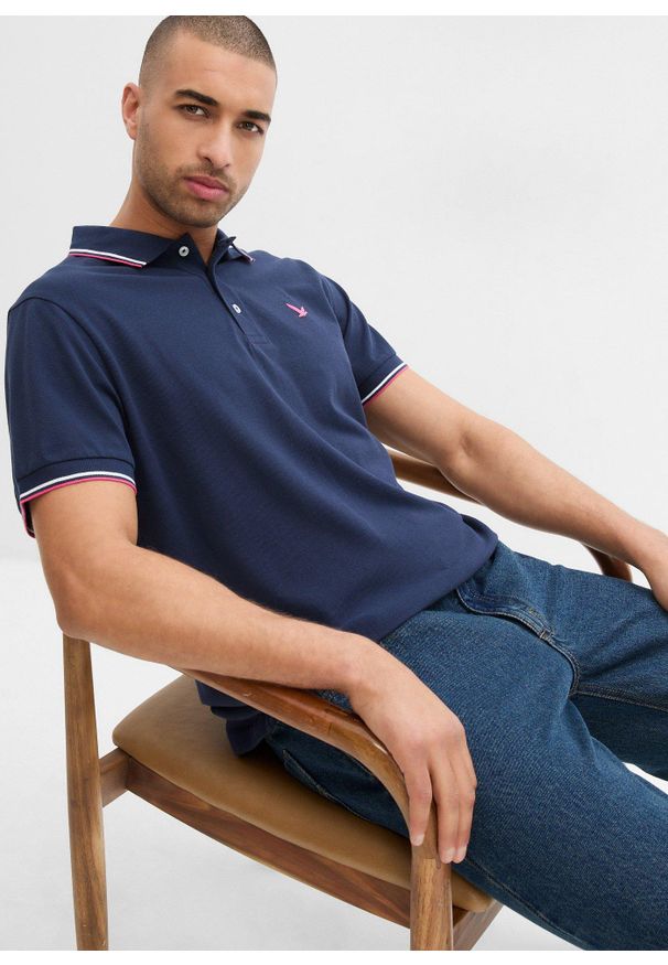 bonprix - Koszulka polo z czystej bawełny organicznej piqué. Typ kołnierza: polo. Kolor: niebieski. Materiał: bawełna. Długość rękawa: krótki rękaw. Długość: krótkie. Wzór: nadruk. Styl: sportowy