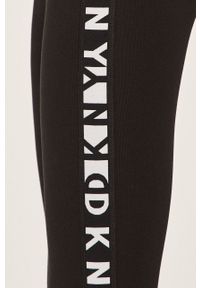 DKNY - Dkny - Legginsy. Kolor: czarny. Materiał: dzianina, materiał. Wzór: gładki