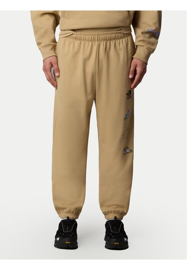 The North Face Spodnie dresowe Unisex Mountain Cleanup NF0A8C2W Beżowy Relaxed Fit. Kolor: beżowy. Materiał: bawełna