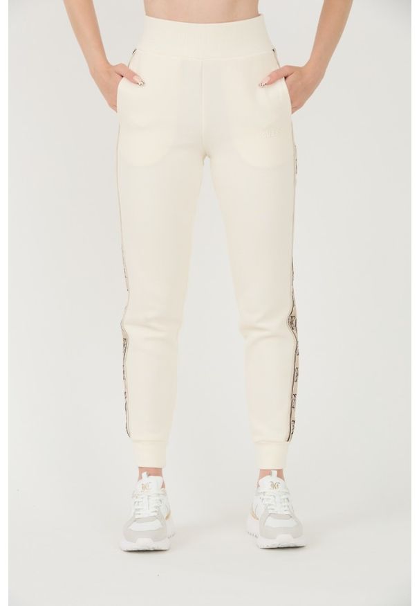 Guess - GUESS Beżowe damskie spodnie dresowe Britney Jogger, Rozmiar XL. Kolor: beżowy. Materiał: dresówka