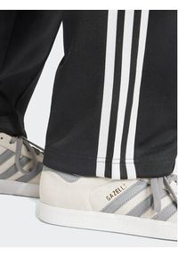 Adidas - adidas Spodnie dresowe adicolor Classics SST IS4102 Czarny Loose Fit. Kolor: czarny. Materiał: syntetyk