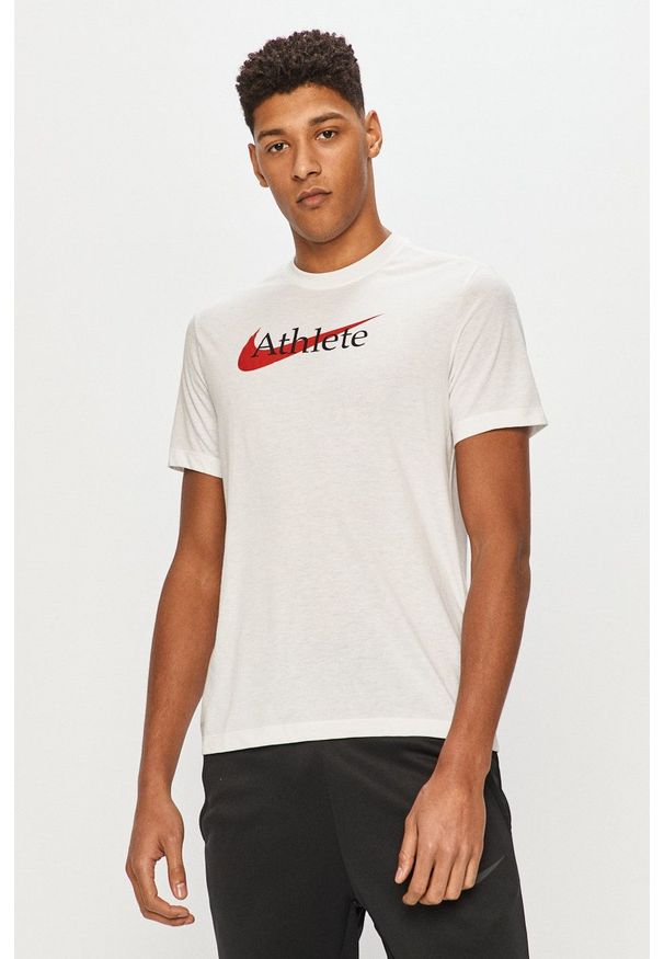 Nike - T-shirt. Okazja: na co dzień. Kolor: biały. Materiał: tkanina, dzianina, skóra, włókno. Wzór: nadruk. Styl: casual