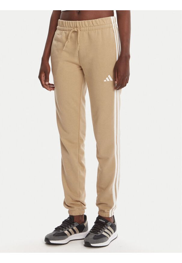 Adidas - adidas Spodnie dresowe Essentials 3-Stripes JX7661 Beżowy Regular Fit. Kolor: beżowy. Materiał: bawełna, syntetyk