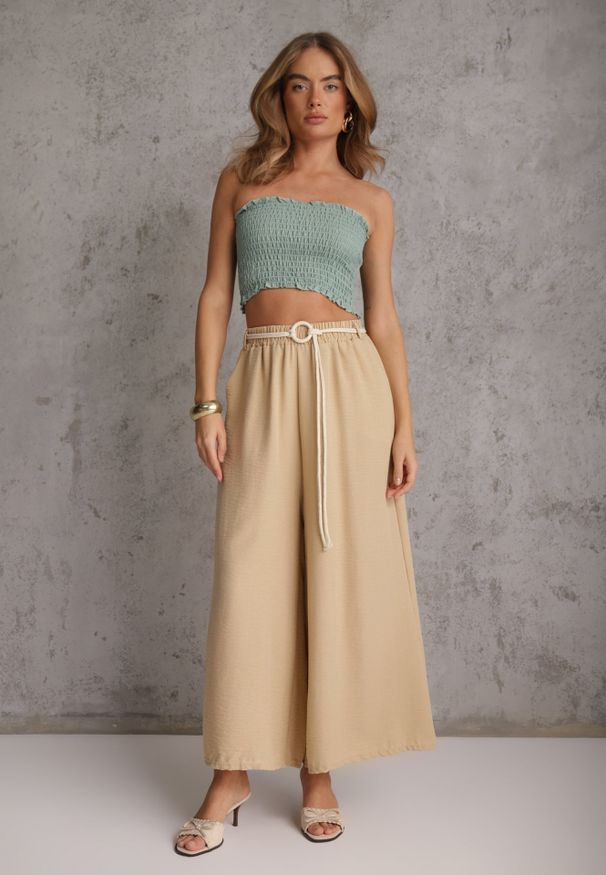 Renee - Beżowe Wiskozowe Spodnie Typu Palazzo High Waist Ozdobione Paskiem Sznurkiem Alemea. Okazja: na co dzień. Stan: podwyższony. Kolor: beżowy. Materiał: wiskoza. Długość: krótkie. Wzór: aplikacja. Styl: casual, boho