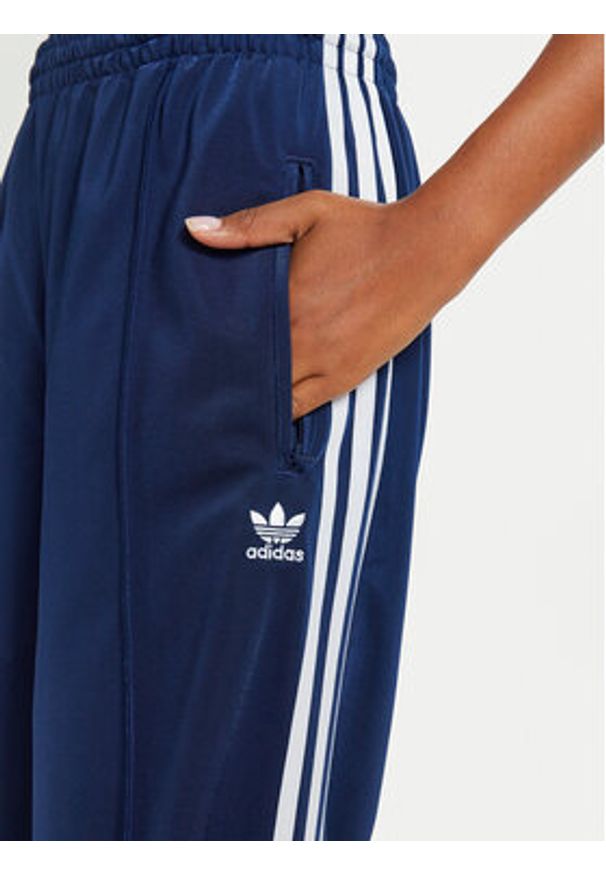Adidas - adidas Spodnie dresowe Firebird IL3817 Granatowy Loose Fit. Kolor: niebieski. Materiał: syntetyk