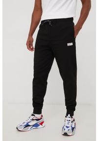 Tommy Jeans spodnie dresowe męskie kolor czarny gładkie. Kolor: czarny. Materiał: dresówka. Wzór: gładki