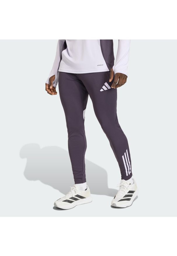Adidas - Spodnie Manchester United Tiro 25 Competition Training. Kolor: fioletowy, wielokolorowy, czarny. Sport: piłka nożna